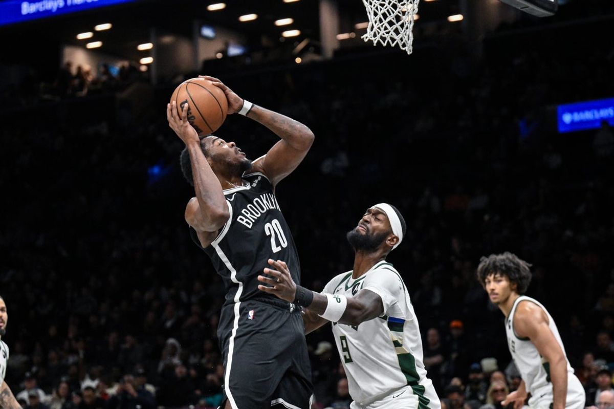 Dec 14, 2025; Brooklyn, New York, USA; Brooklyn Nets center Day'Ron Sharpe (20) shoots the ball defended by Milwaukee Bucks forward Bobby Portis (9) during the second half at Barclays Center. Mandatory Credit: John Jones-Imagn Images