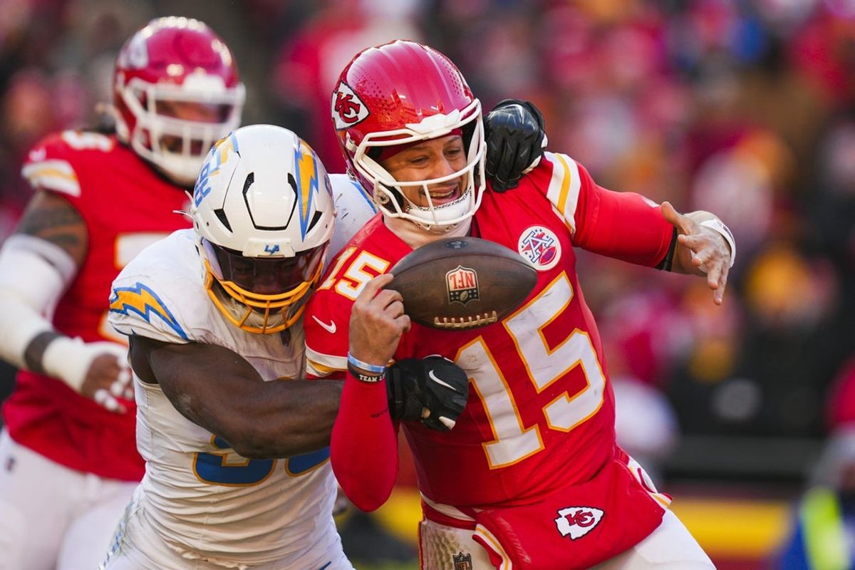 Dec 14, 2025; Kansas City, Missouri, USA; Los Angeles Chargers linebacker Odafe Oweh (98) sacks Kansas City Chiefs quarterback Patrick Mahomes (15) during the second half at GEHA Field at Arrowhead Stadium. Mandatory Credit: Jay Biggerstaff-Imagn Images