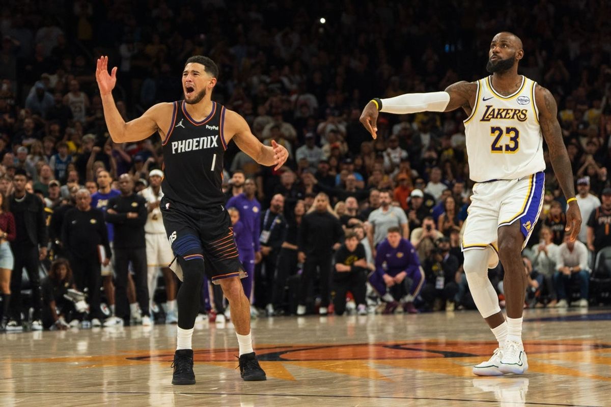 Dec 14, 2025; Phoenix, Arizona, USA;   Phoenix Suns guard Devin Booker (1) reacts after being called for a foul on Los Angeles Lakers forward LeBron James (23) during the final seconds of the game at Mortgage Matchup Center. Mandatory Credit: Allan Henry-Imagn Images