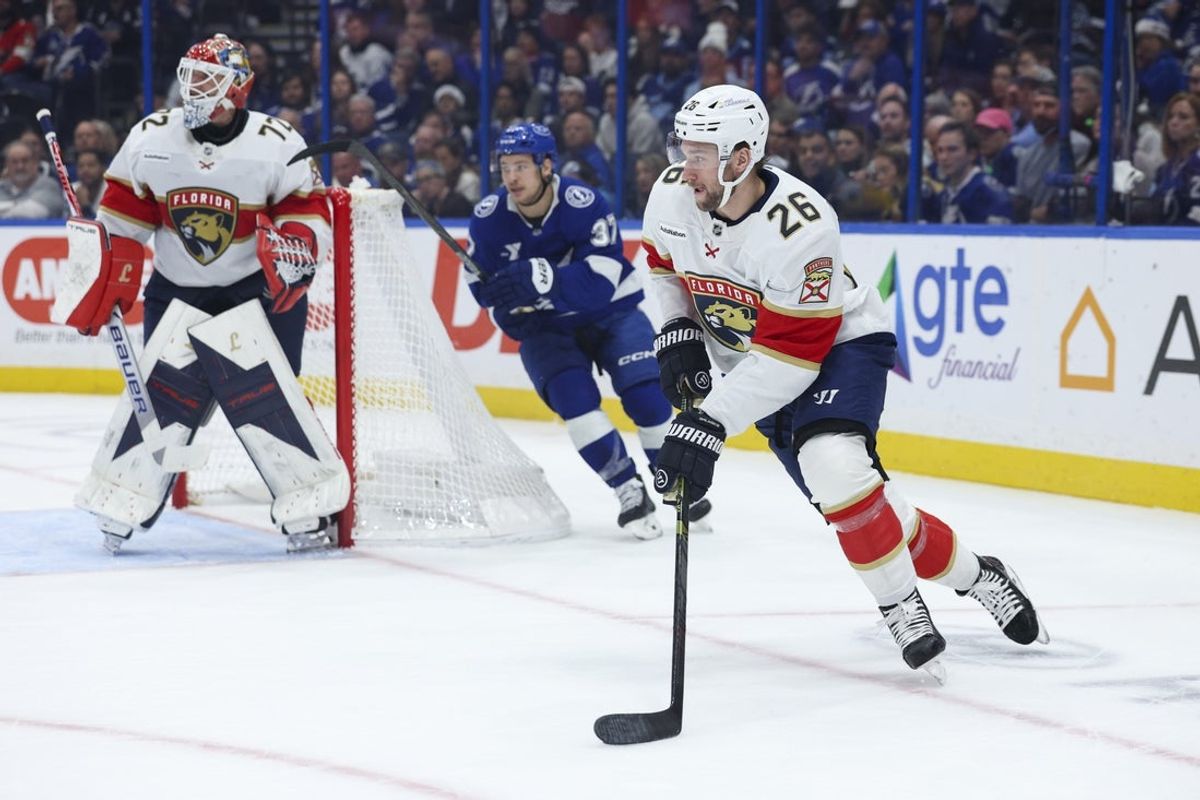 Dec 15, 2025; Tampa, Florida, USA; Florida Panthers defenseman Uvis Balinskis (26) controls the puck against the Tampa Bay Lightning in the first period at Benchmark International Arena. Mandatory Credit: Nathan Ray Seebeck-Imagn Images