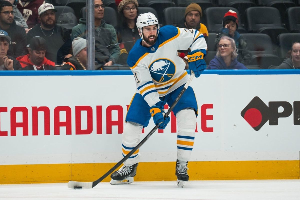 Dec 11, 2025; Vancouver, British Columbia, CAN; Buffalo Sabres defenseman Conor Timmins (21) handles the puck against the Vancouver Canucks in the first period at Rogers Arena. Mandatory Credit: Bob Frid-Imagn Images