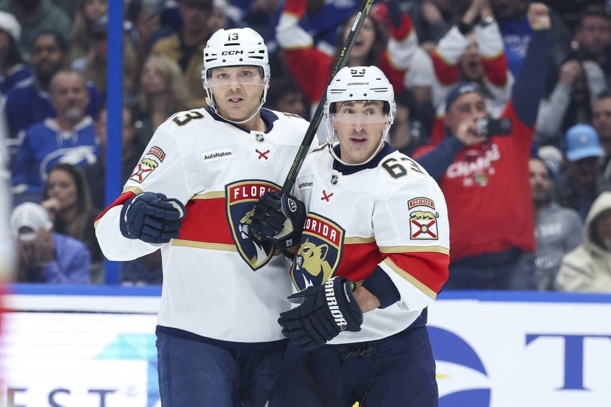 Dec 15, 2025; Tampa, Florida, USA; Florida Panthers left wing Brad Marchand (63) reacts to a goal scored by center Sam Reinhart (13) against the Tampa Bay Lightning in the second period at Benchmark International Arena. Mandatory Credit: Nathan Ray Seebeck-Imagn Images
