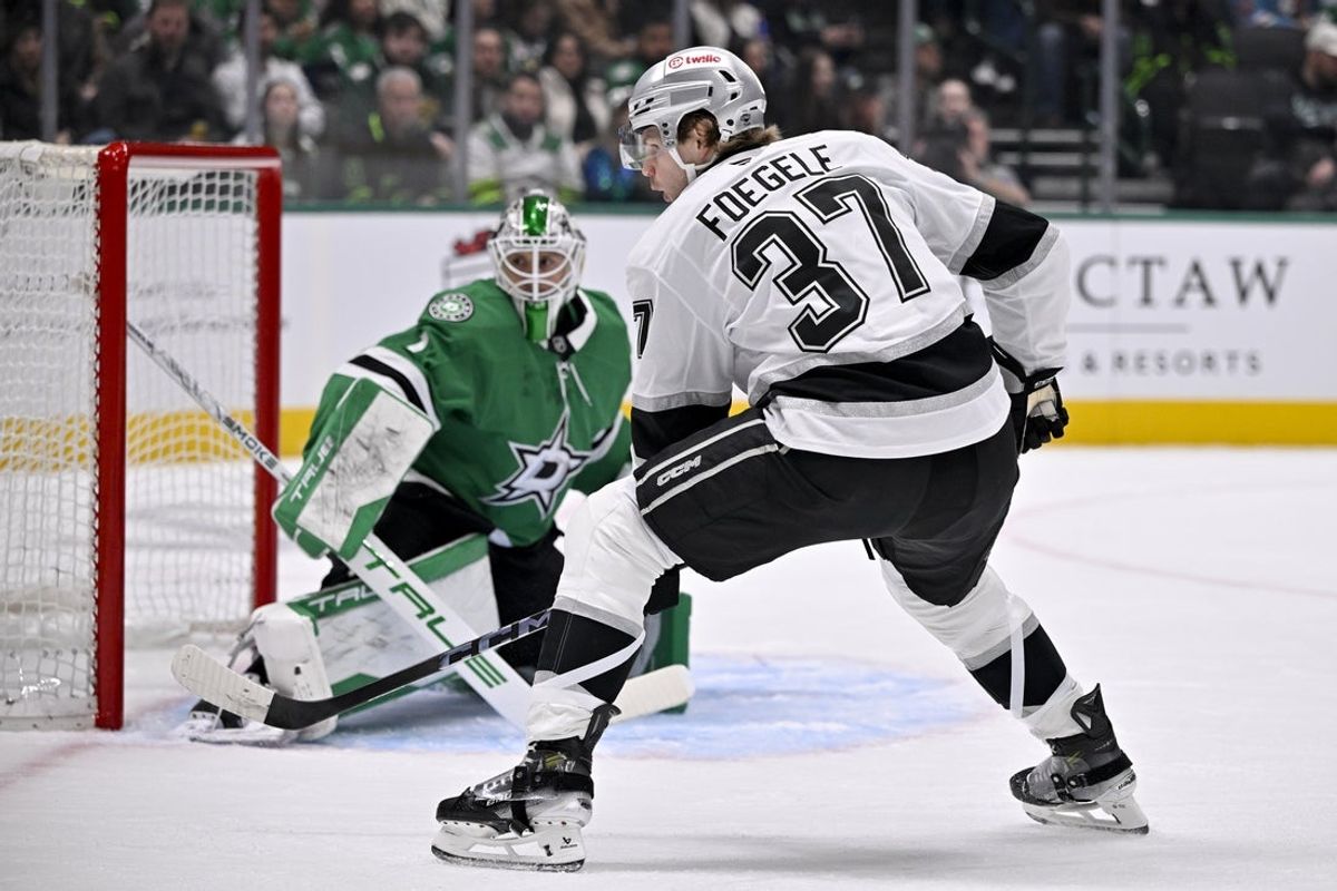 Dec 15, 2025; Dallas, Texas, USA; Dallas Stars goaltender Casey Desmith (1) stops a shot by Los Angeles Kings left wing Warren Foegele (37) during the first period at the American Airlines Center. Mandatory Credit: Jerome Miron-Imagn Images