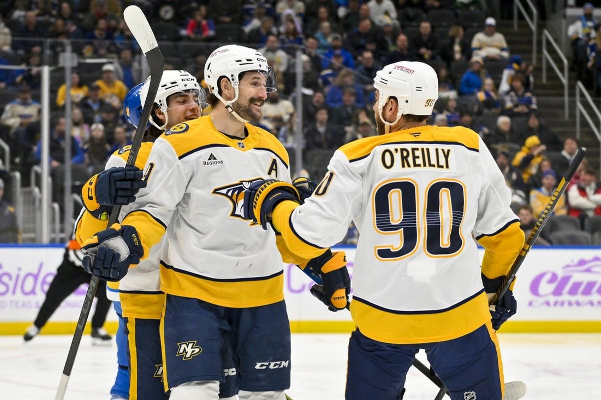 Dec 15, 2025; St. Louis, Missouri, USA; Nashville Predators left wing Filip Forsberg (9) celebrates with right wing Luke Evangelista (77) and center Ryan O'Reilly (90) after scoring against the St. Louis Blues during the first period at Enterprise Center. Mandatory Credit: Jeff Curry-Imagn Images
