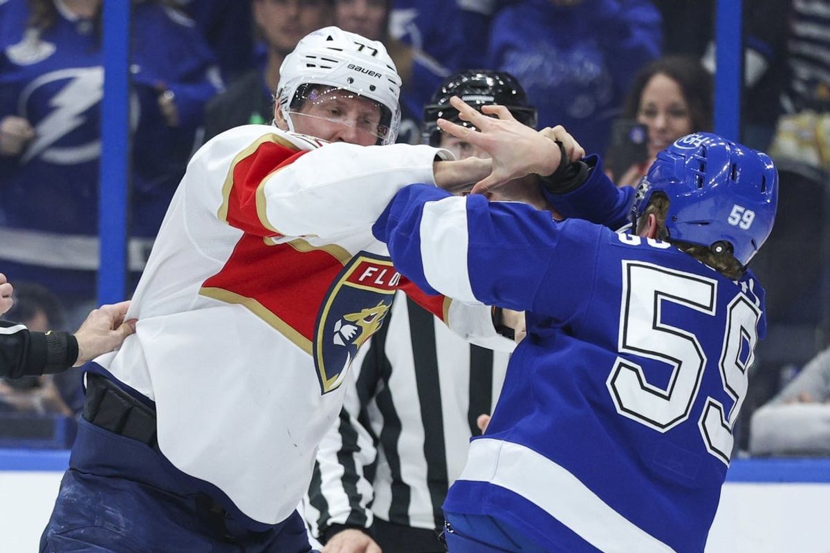 Dec 15, 2025; Tampa, Florida, USA; Tampa Bay Lightning center Jake Guentzel (59) and Florida Panthers defenseman Niko Mikkola (77) exchange shoves in the third period at Benchmark International Arena. Mandatory Credit: Nathan Ray Seebeck-Imagn Images