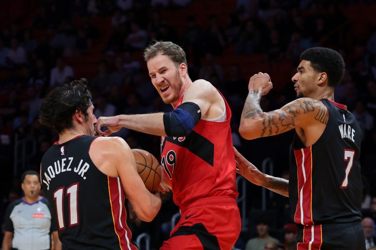Dec 15, 2025; Miami, Florida, USA; Miami Heat forward Jaime Jaquez Jr. (11) grabs a rebound against Toronto Raptors center Jakob Poeltl (19) during the second quarter at Kaseya Center. Mandatory Credit: Sam Navarro-Imagn Images