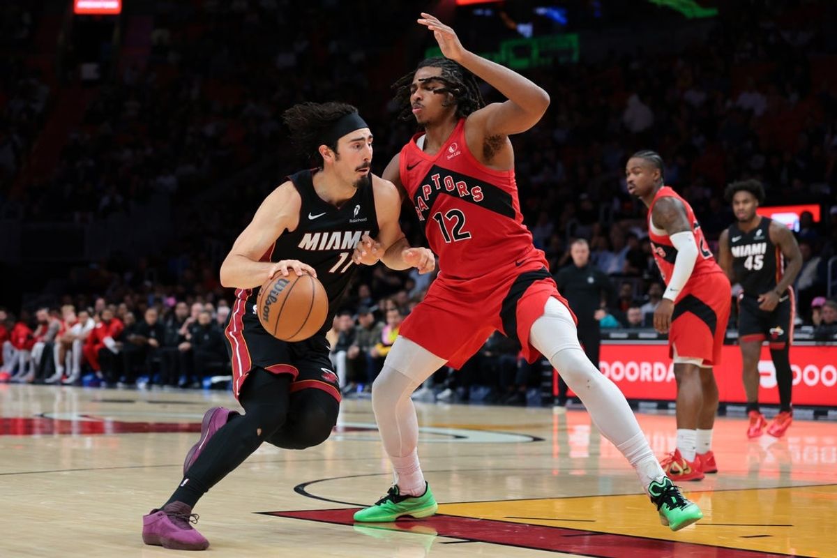 Dec 15, 2025; Miami, Florida, USA; Miami Heat forward Jaime Jaquez Jr. (11) drives to the basket against Toronto Raptors forward Collin Murray-Boyles (12) during the fourth quarter at Kaseya Center. Mandatory Credit: Sam Navarro-Imagn Images