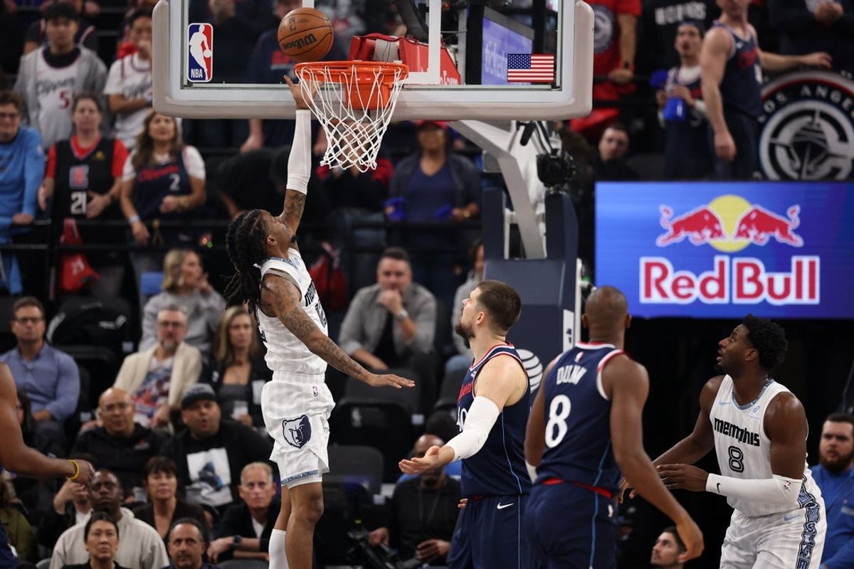 Dec 15, 2025; Inglewood, California, USA;  Memphis Grizzlies guard Ja Morant (12) makes a layup against Los Angeles Clippers center Ivica Zubac (40) during the first quarter at Intuit Dome. Mandatory Credit: Kiyoshi Mio-Imagn Images