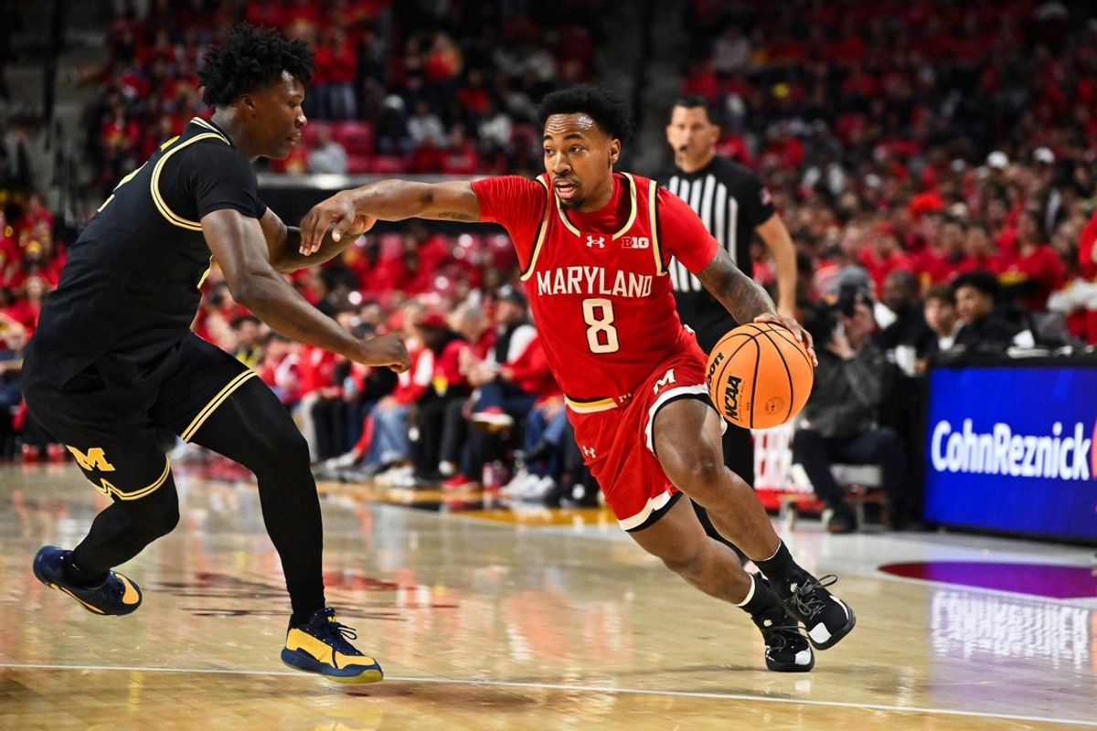 Dec 13, 2025; College Park, Maryland, USA;  Maryland Terrapins guard David Coit (8) controls the ball against the Michigan Wolverines at Xfinity Center. Mandatory Credit: Jamie Sabau-Imagn Images