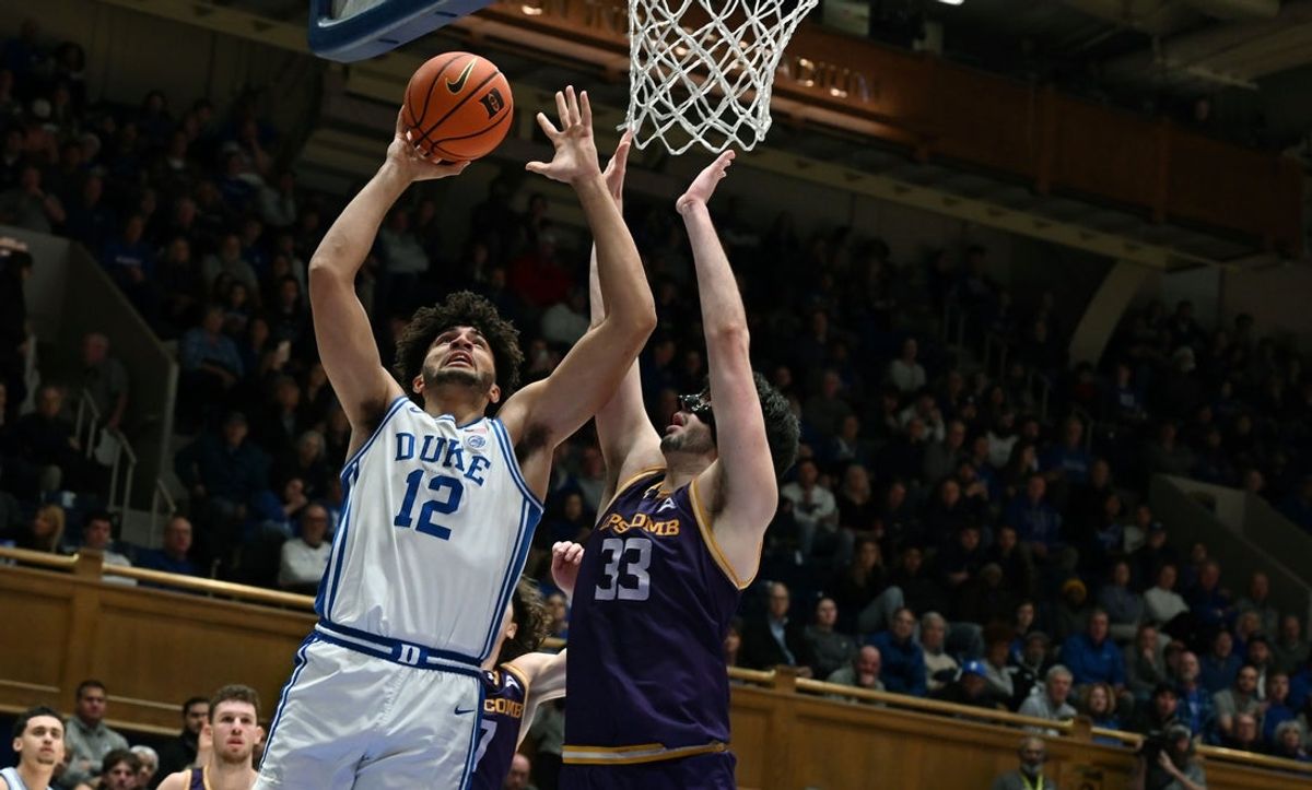 Dec 16, 2025; Durham, North Carolina, USA;  Duke Blue Devils forward Cameron Boozer (12) shoots over Lipscomb Bisons center Charlie Williams (33) during the first half at Cameron Indoor Stadium. Mandatory Credit: Rob Kinnan-Imagn Images
