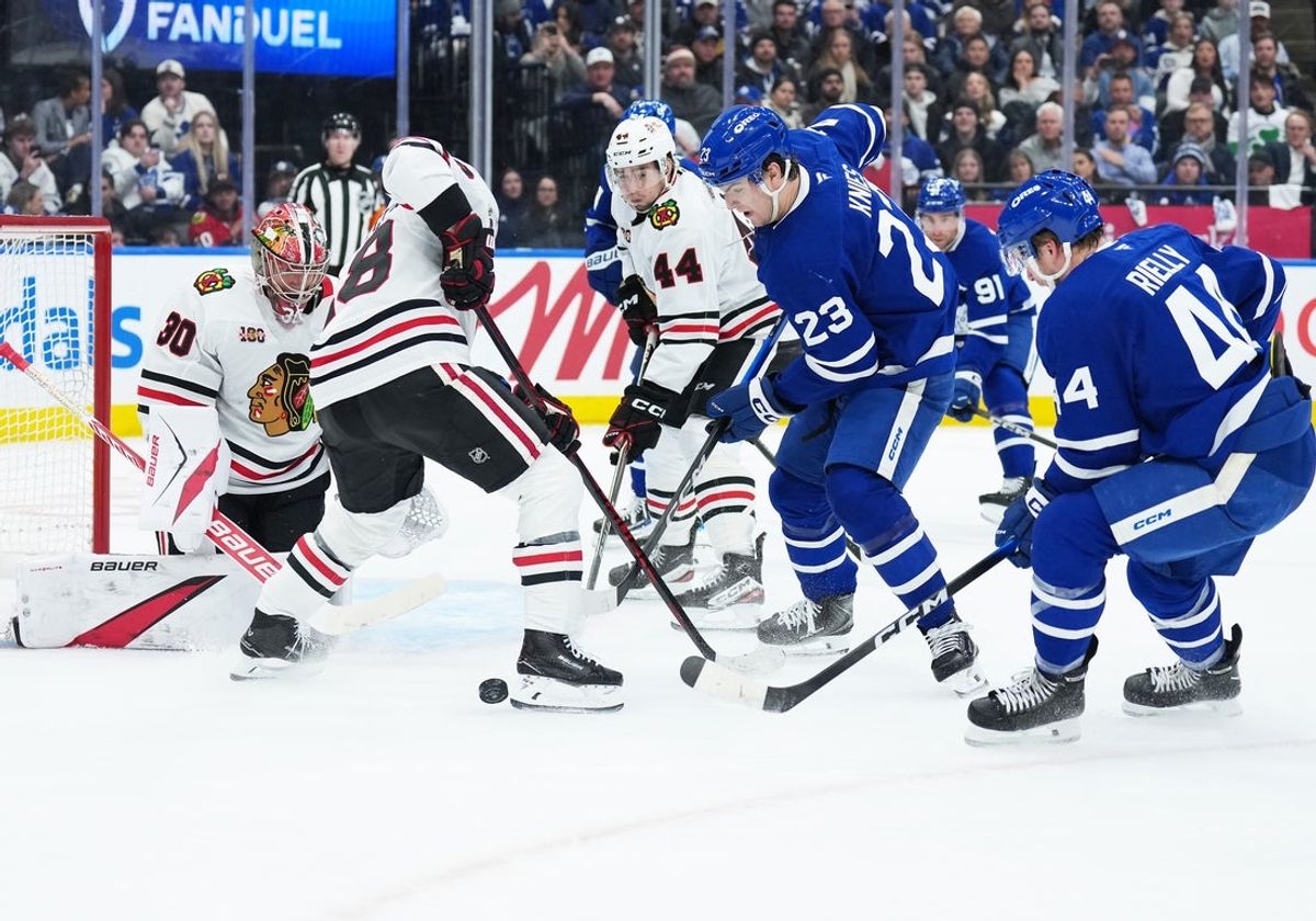 Dec 16, 2025; Toronto, Ontario, CAN; Toronto Maple Leafs left wing Matthew Knies (23) battles for the puck with Chicago Blackhawks defenseman Matt Grzelcyk (48) during the first period at Scotiabank Arena. Mandatory Credit: Nick Turchiaro-Imagn Images