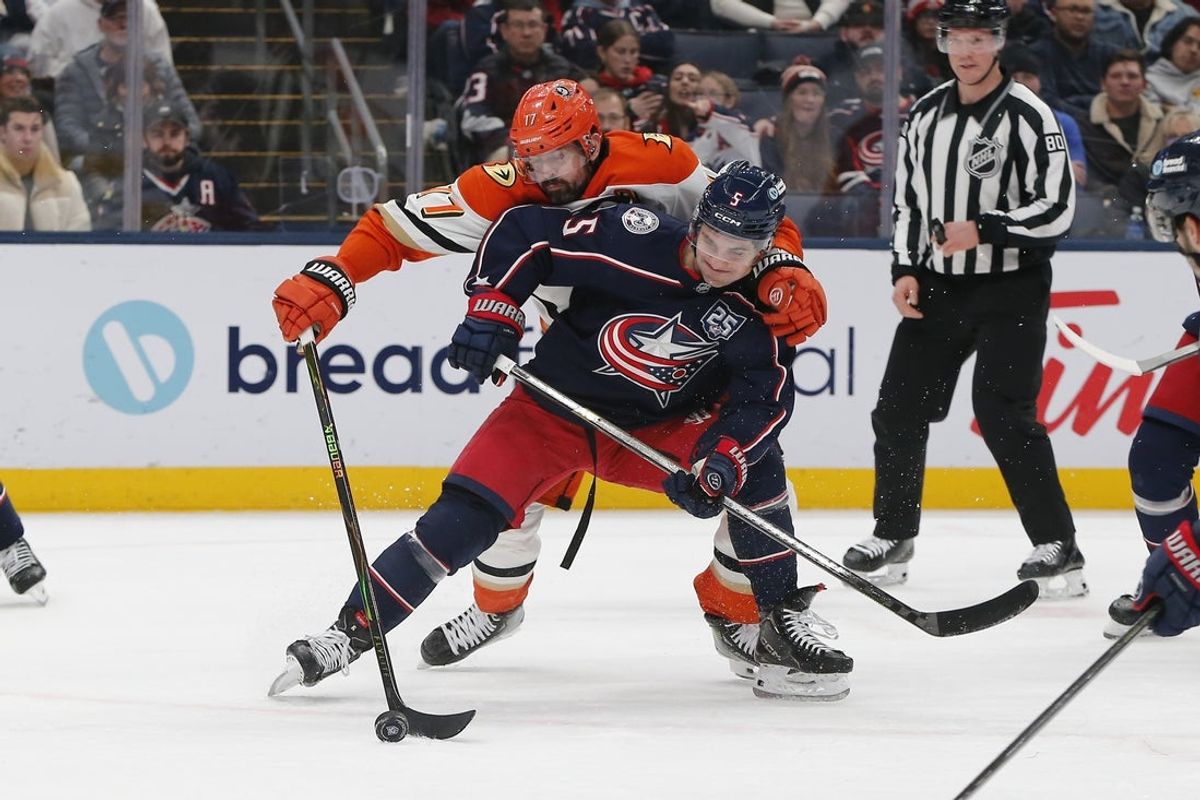 Dec 16, 2025; Columbus, Ohio, USA; Anaheim Ducks left wing Alex Killorn (17) reaches for the puck over Columbus Blue Jackets defenseman Denton Mateychuk (5) during the first period at Nationwide Arena. Mandatory Credit: Russell LaBounty-Imagn Images