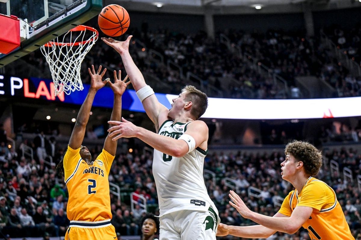 Michigan State's Jaxon Kohler, right, lays it in as Toledo's Leroy Blyden Jr. defends during the first half on Tuesday, Dec. 16, 2025, at the Breslin Center in East Lansing.