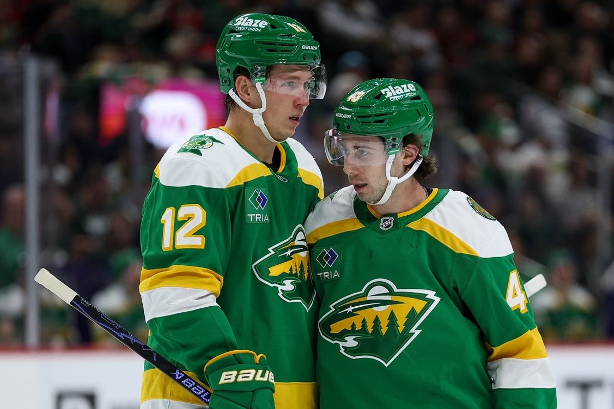 Dec 16, 2025; Saint Paul, Minnesota, USA; Minnesota Wild left wing Matt Boldy (12) and defenseman Quinn Hughes (43) talk before a power play against the Washington Capitals during the first period at Grand Casino Arena. Mandatory Credit: Matt Krohn-Imagn Images