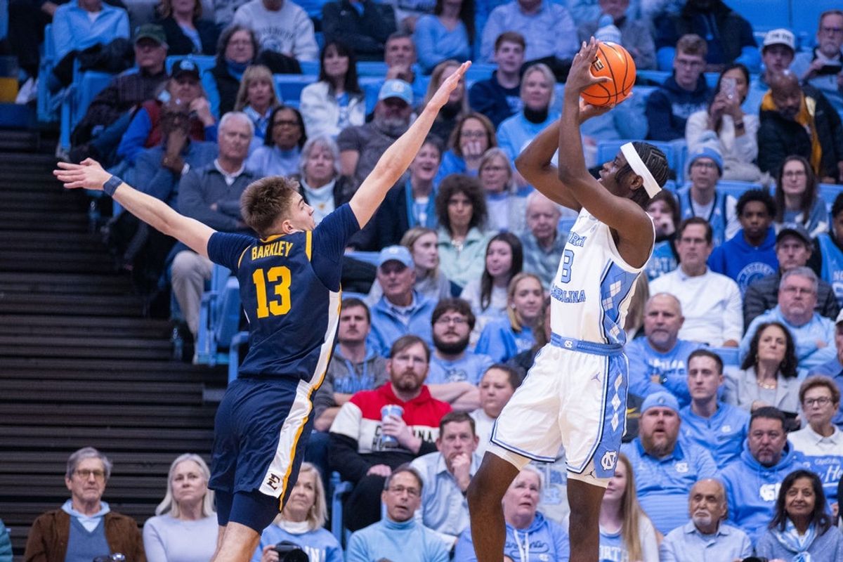 Dec 16, 2025; Chapel Hill, North Carolina, USA; North Carolina Tar Heels forward Caleb Wilson (8) shoots on ETSU Buccaneers forward Blake Barkley (13) during the first half at Dean E. Smith Center. Mandatory Credit: Scott Kinser-Imagn Images