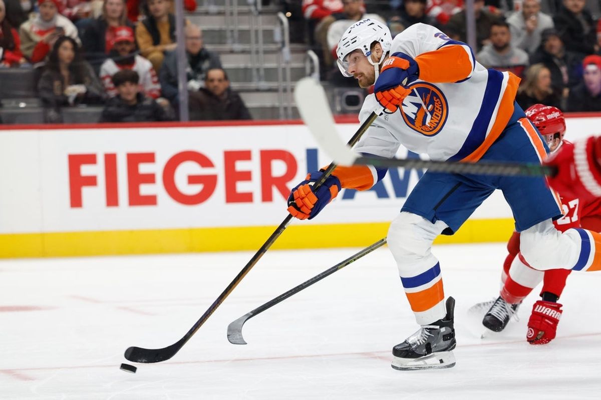 Dec 16, 2025; Detroit, Michigan, USA;  New York Islanders defenseman Scott Mayfield (24) takes a shot in the third period against the Detroit Red Wings at Little Caesars Arena. Mandatory Credit: Rick Osentoski-Imagn Images