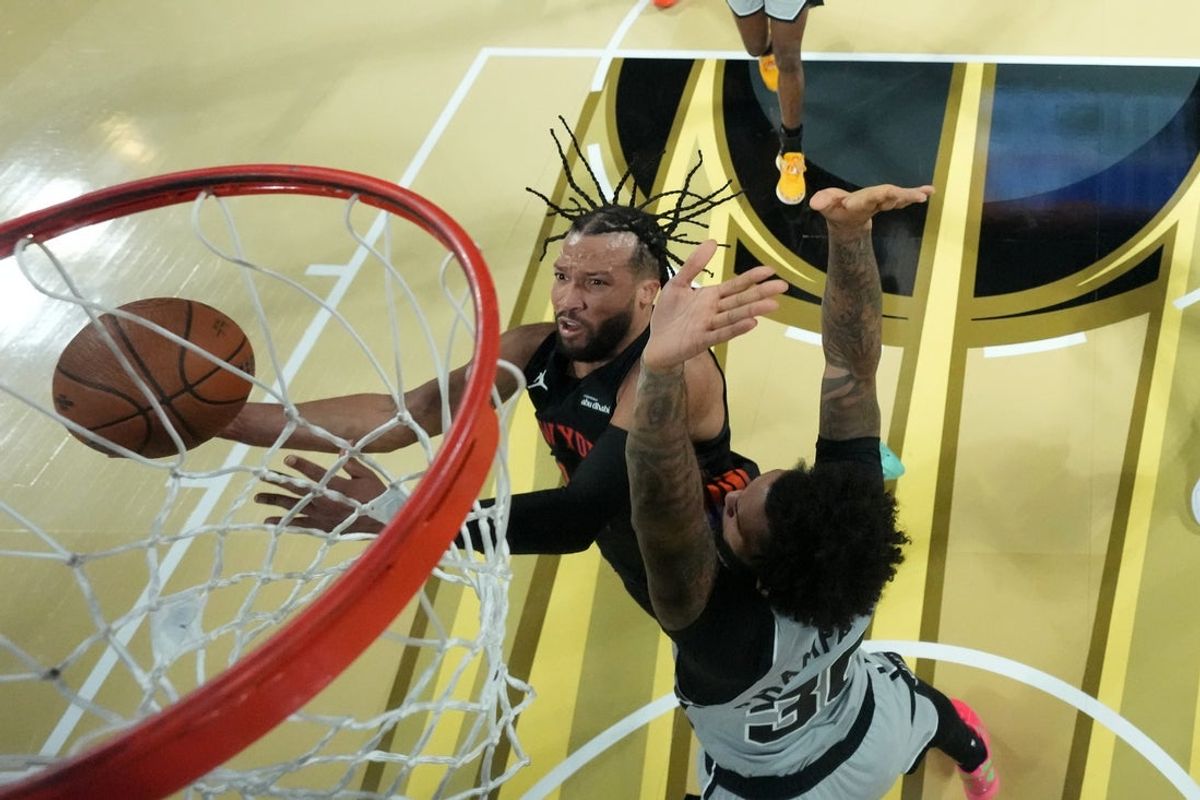 Dec 16, 2025; Las Vegas, Nevada, USA; New York Knicks guard Jalen Brunson (11) shoots the ball past San Antonio Spurs forward Julian Champagnie (30) during the Emirates NBA Cup Final at T-Mobile Arena. Mandatory Credit: Kirby Lee-Imagn Images