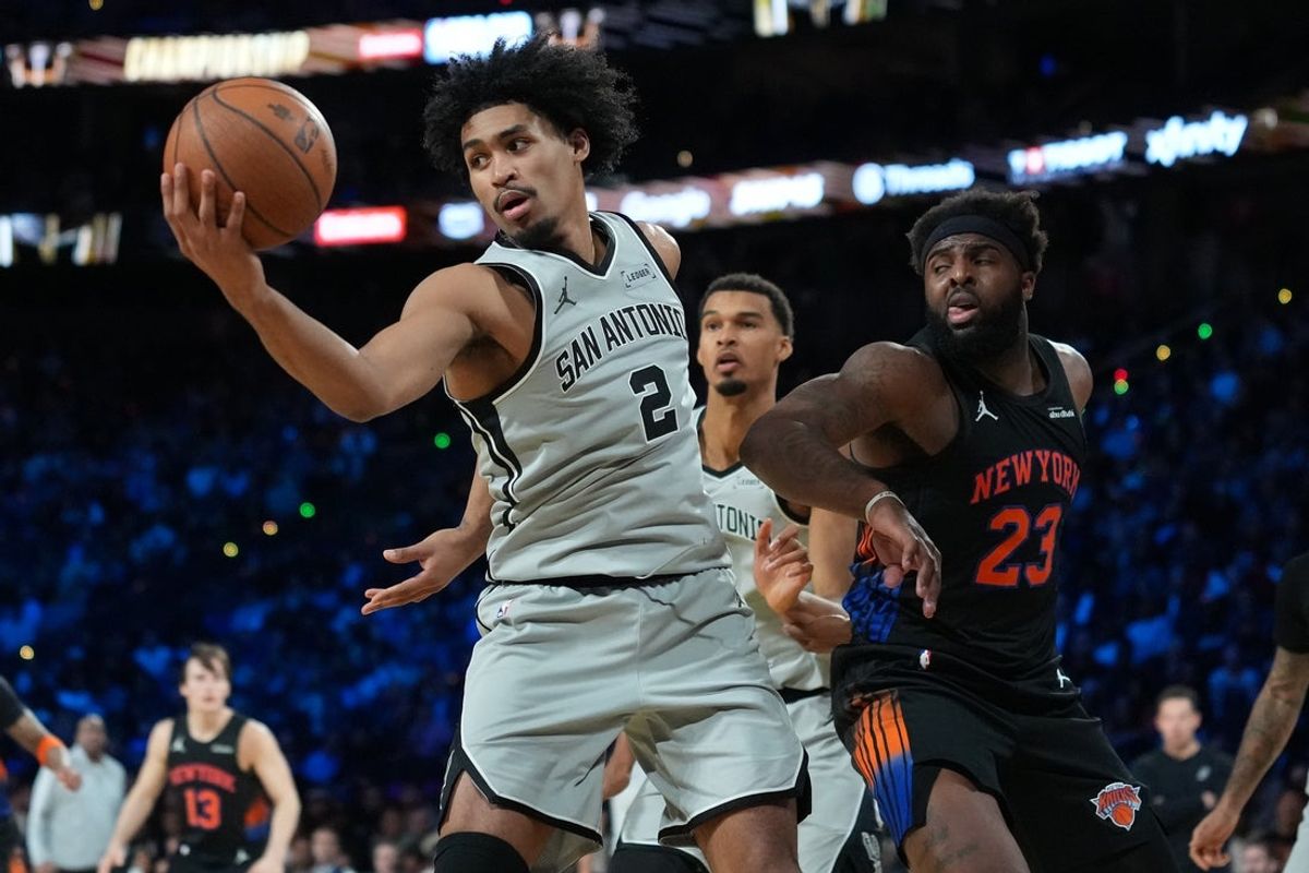 Dec 16, 2025; Las Vegas, Nevada, USA; San Antonio Spurs guard Dylan Harper (2) grabs a rebound against the New York Knicks in the second half during the Emirates NBA Cup Final at T-Mobile Arena. Mandatory Credit: Kirby Lee-Imagn Images