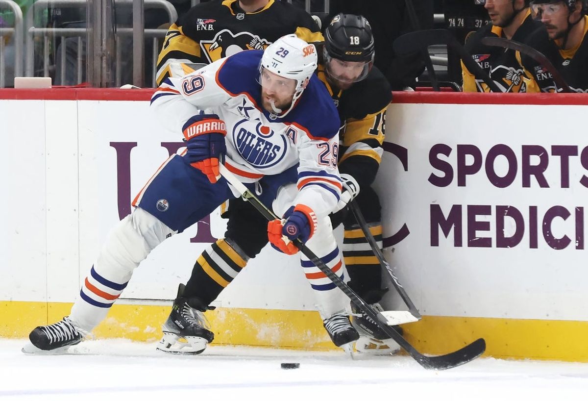 Dec 16, 2025; Pittsburgh, Pennsylvania, USA;  Edmonton Oilers center Leon Draisaitl (29) and Pittsburgh Penguins center Tommy Novak (18) battle for the puck during the first period at PPG Paints Arena. Mandatory Credit: Charles LeClaire-Imagn Images