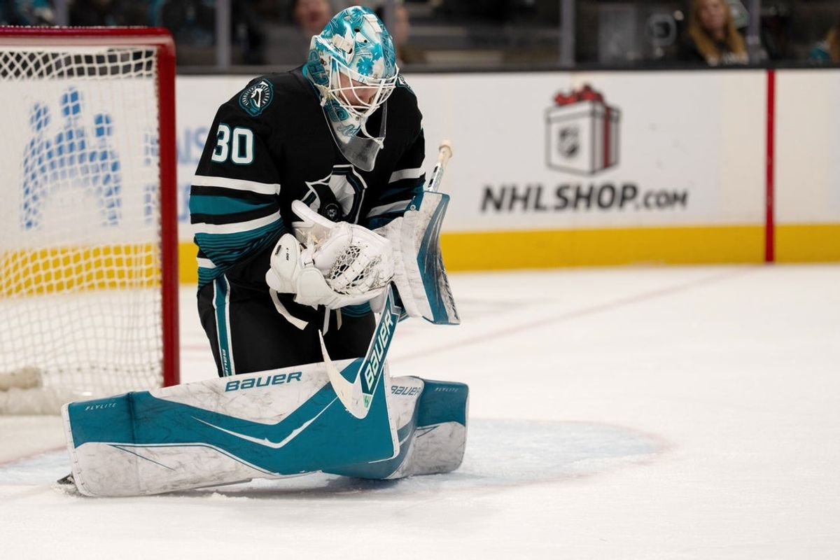 Dec 16, 2025; San Jose, California, USA; San Jose Sharks goaltender Yaroslav Askarov (30) makes a save against the Calgary Flames during the first period at SAP Center at San Jose. Mandatory Credit: Neville E. Guard-Imagn Images