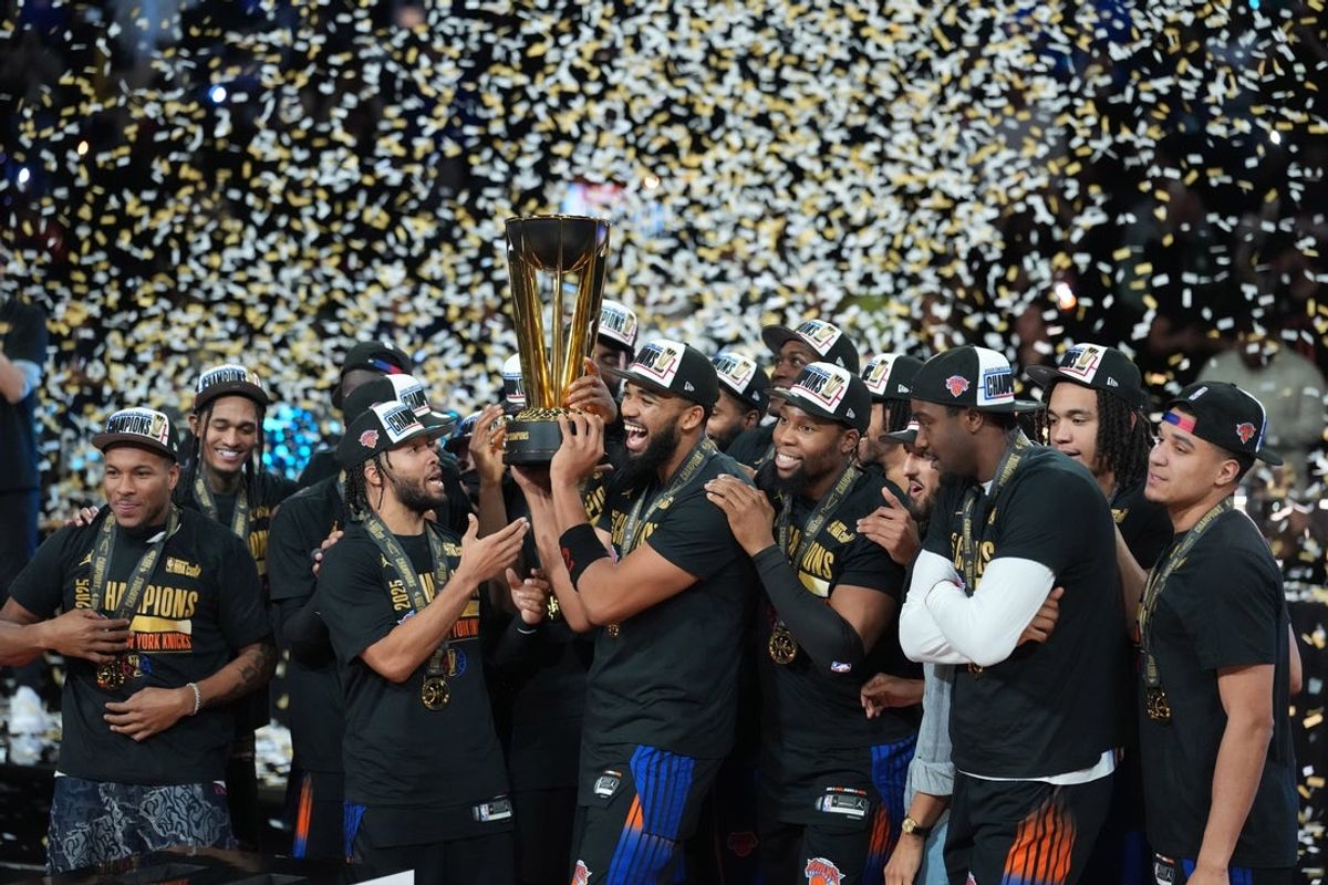 Dec 16, 2025; Las Vegas, Nevada, USA; New York Knicks center/forward Karl-Anthony Towns (32) and guard Jalen Brunson (11) hold the the Emirates NBA Cup trophy after victory over the San Antonio Spurs at T-Mobile Arena. Mandatory Credit: Kirby Lee-Imagn Images