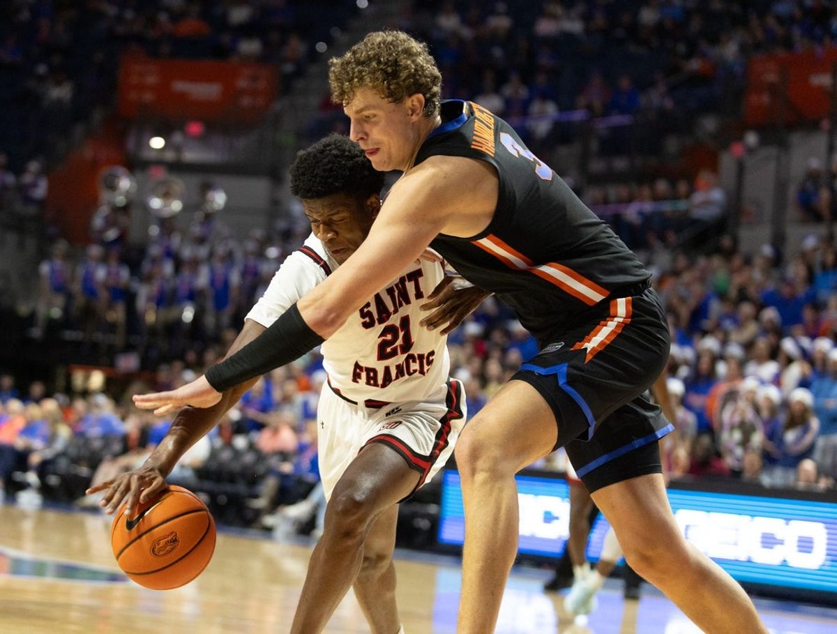 Florida center Micah Handlogten (3) pressures Saint Francis forward Gestin Liberis (21) during the first half of an NCAA mens basketball game at Steven C. O'Connell Center Exactek arena in Gainesville, FL on Wednesday, December 17, 2025. Florida won 76-51[Alan Youngblood/Gainesville Sun]