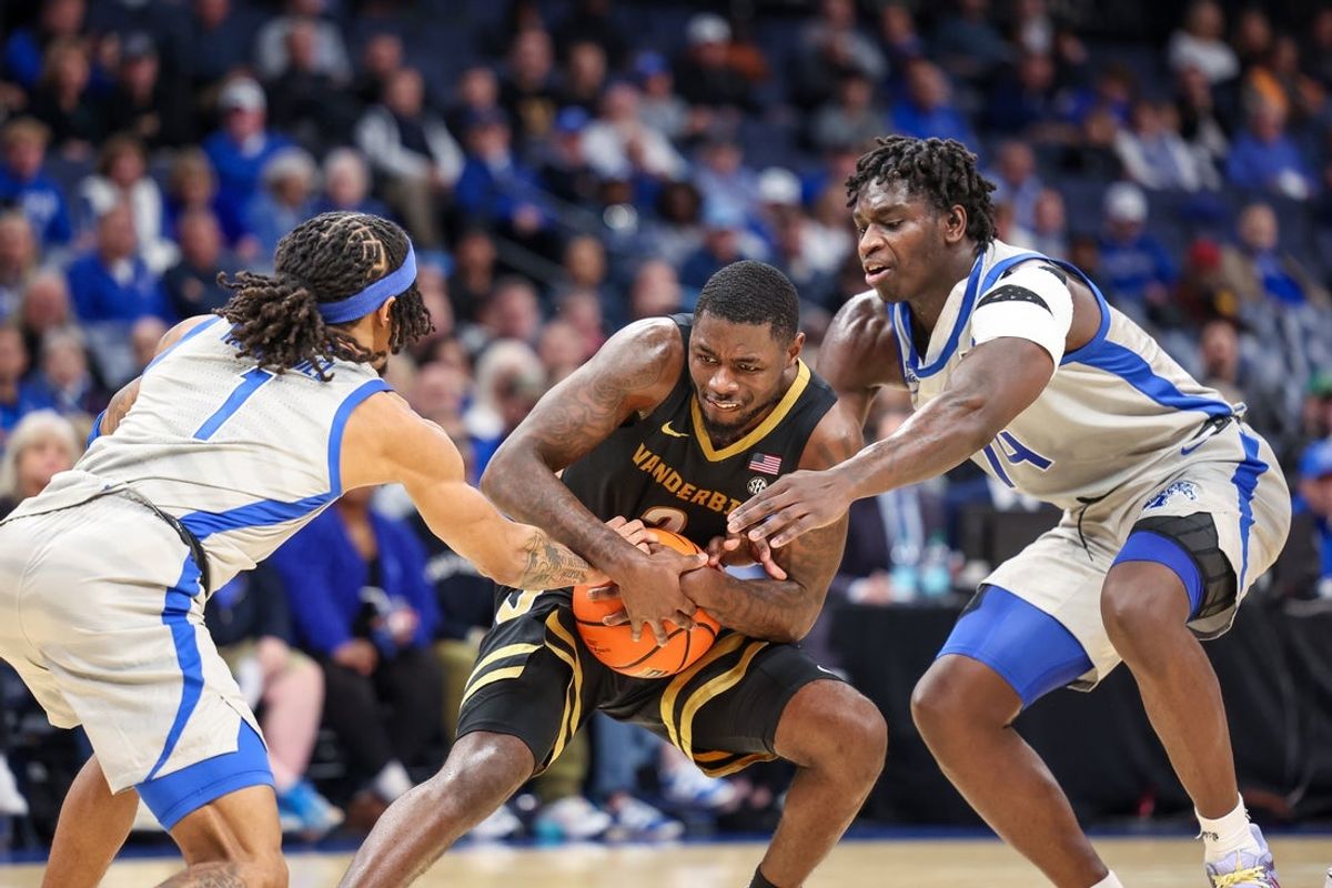 Dec 17, 2025; Memphis, Tennessee, USA; Vanderbilt Commodores guard Duke Miles (2) and Memphis Tigers guard Dug McDaniel (1) reach for a rebound during the first half at FedExForum. Mandatory Credit: Wesley Hale-Imagn Images