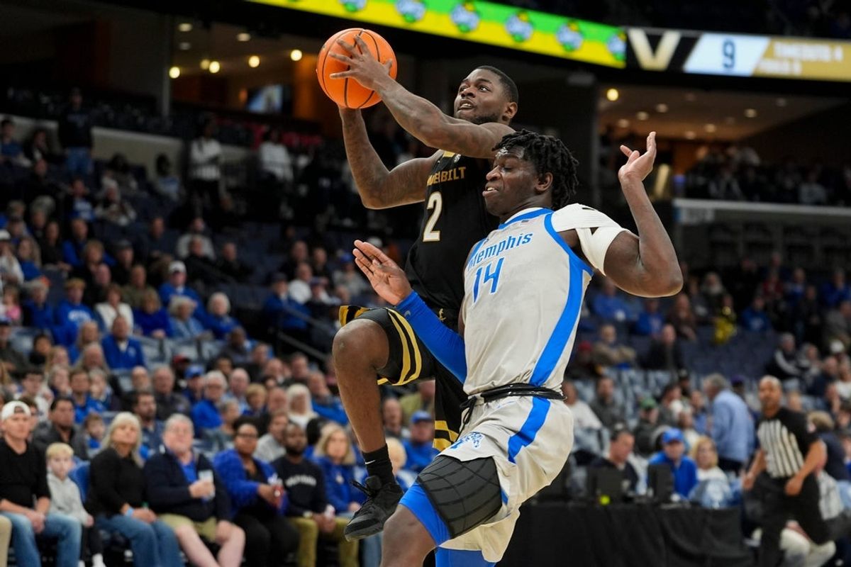 Vanderbilt's Duke Miles (2) goes for a layup as Memphis' Hasan Abdul Hakim (14) guards him during the game between Memphis and Vanderbilt at FedExForum in Memphis, Tenn., on December 17, 2025.