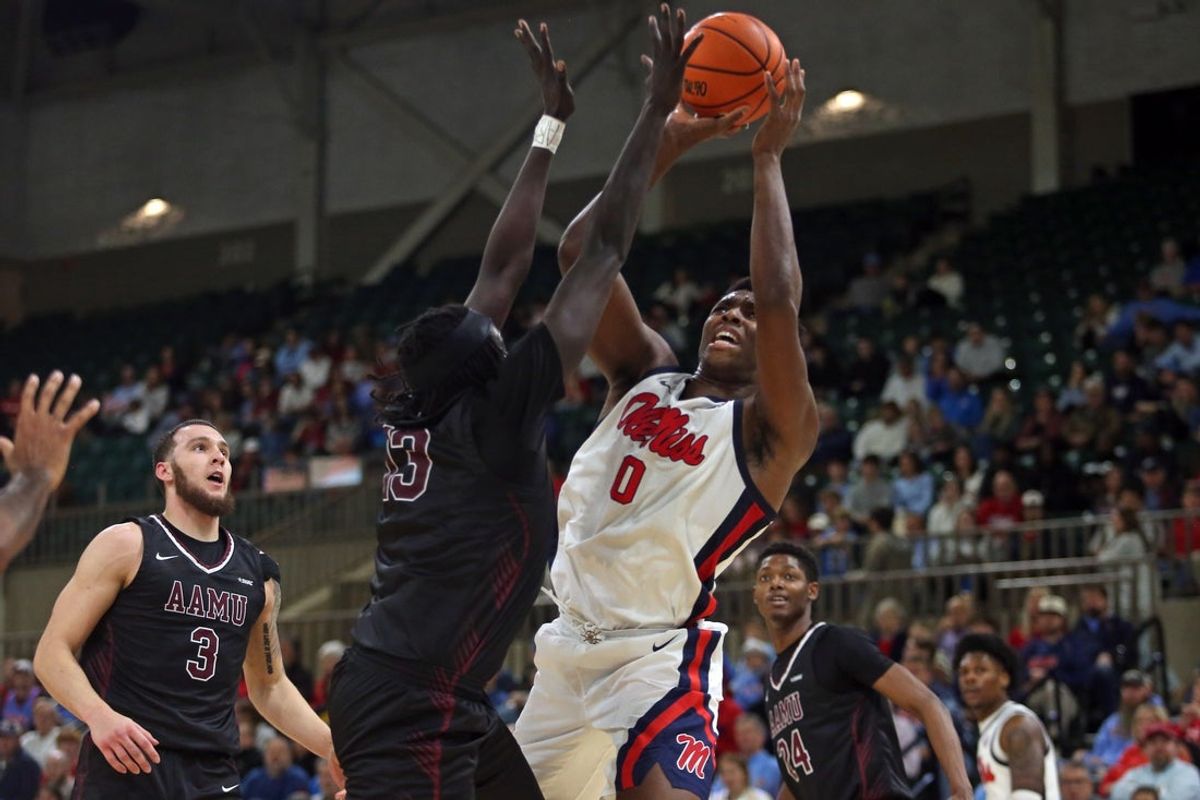 Dec 17, 2025; Tupelo, Mississippi, USA; Mississippi Rebels forward Malik Dia (0) drives to the basket as Alabama A&M Bulldogs forward Angok Anyang (13) defends during the first half at Cadence Bank Arena. Mandatory Credit: Petre Thomas-Imagn Images