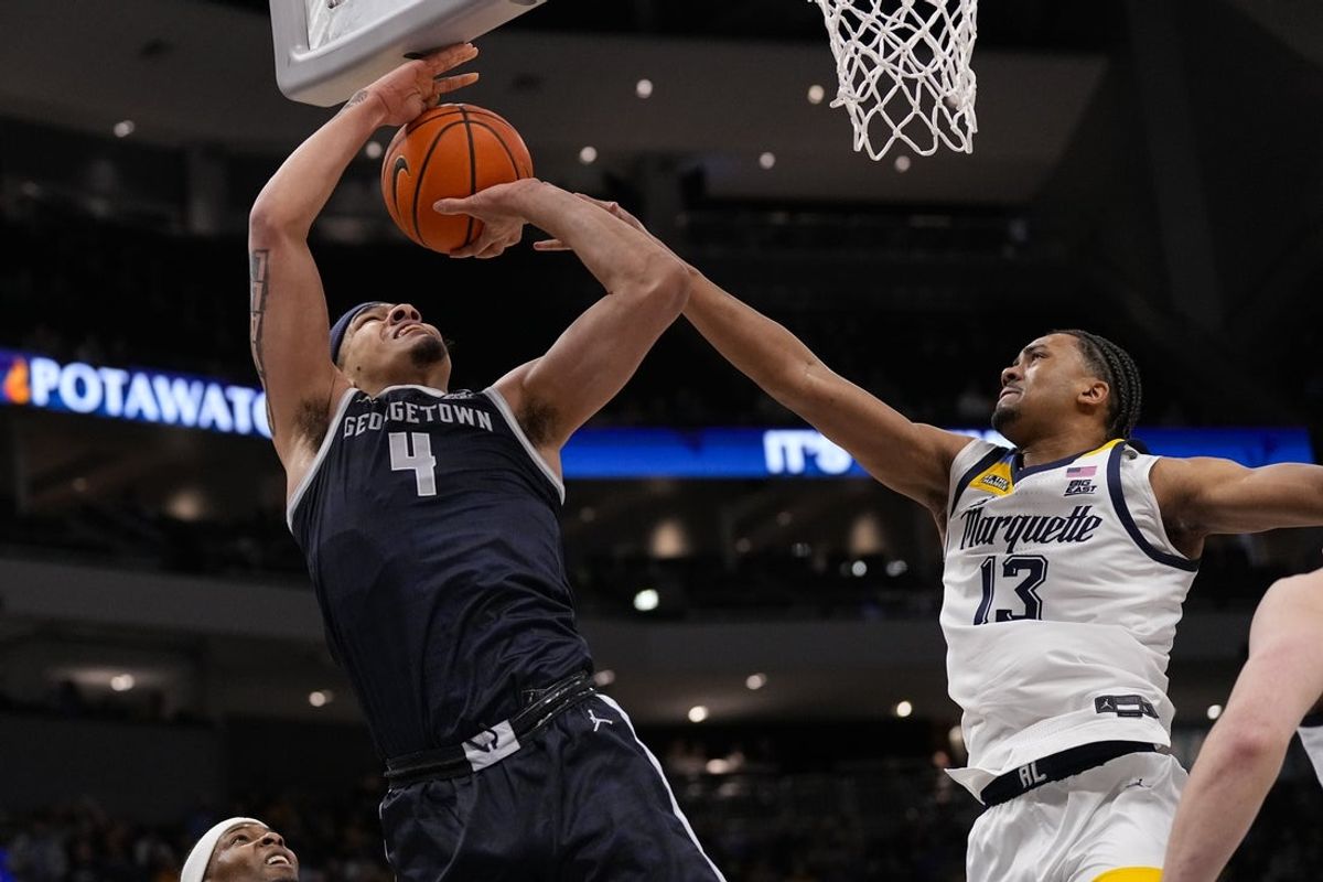 Dec 17, 2025; Milwaukee, Wisconsin, USA;  Georgetown Hoyas forward Caleb Williams (4) shoots against Marquette Golden Eagles forward Royce Parham (13) during the first half at Fiserv Forum. Mandatory Credit: Jeff Hanisch-Imagn Images