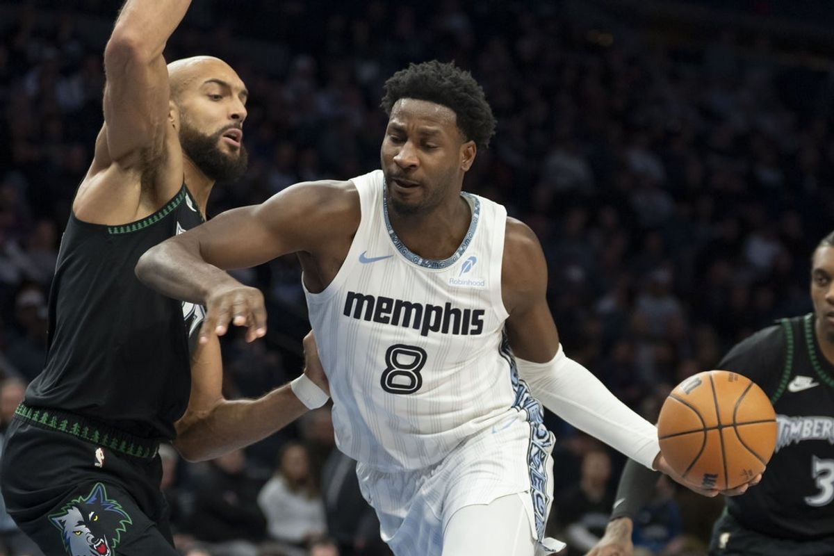 Dec 17, 2025; Minneapolis, Minnesota, USA; Memphis Grizzlies forward Jaren Jackson Jr. (8) dribbles the ball as Minnesota Timberwolves center Rudy Gobert (27) plays defense in the first half at Target Center. Mandatory Credit: Jesse Johnson-Imagn Images