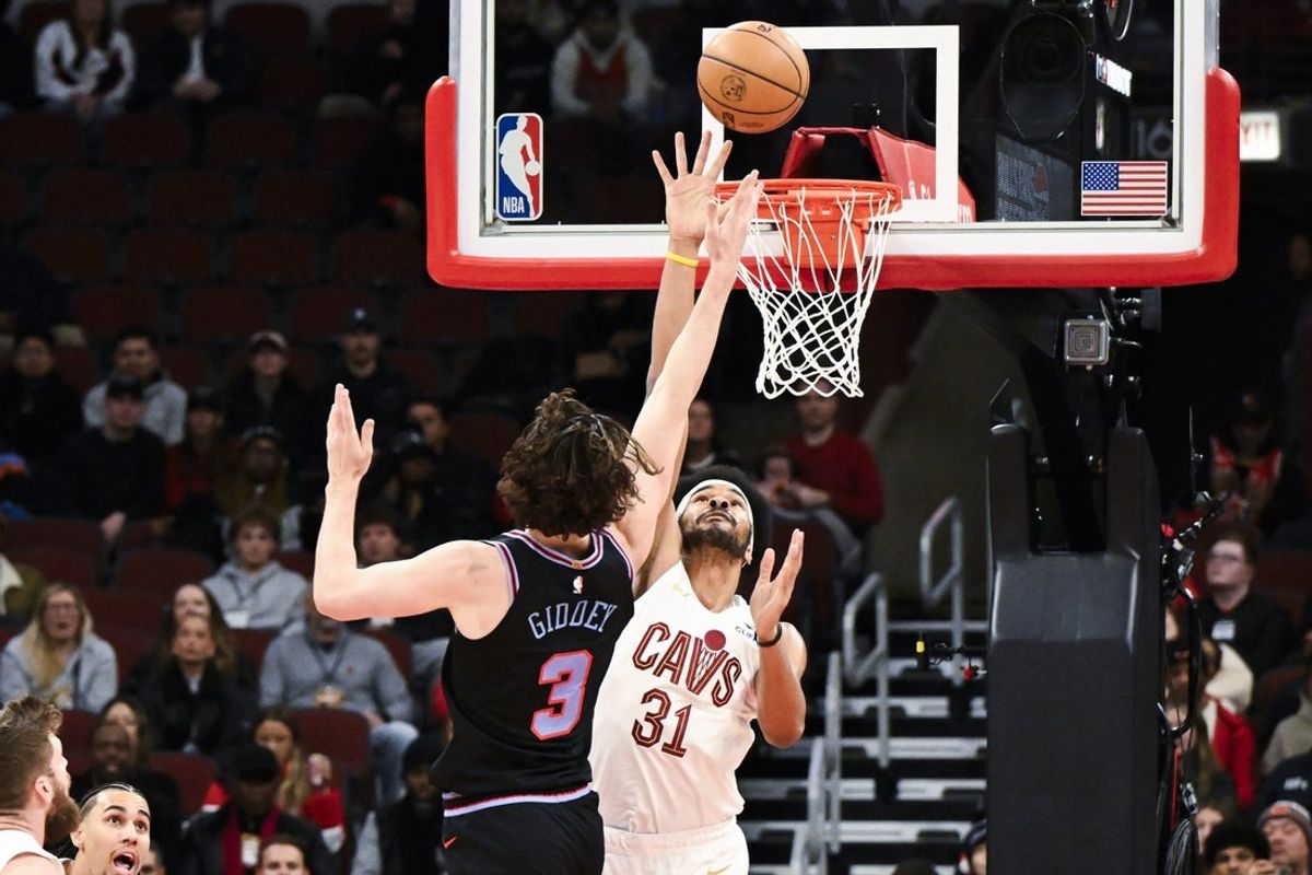 Dec 17, 2025; Chicago, Illinois, USA;  Chicago Bulls guard Josh Giddey (3) shoots against Cleveland Cavaliers center Jarrett Allen (31) during the first half at United Center. Mandatory Credit: Matt Marton-Imagn Images