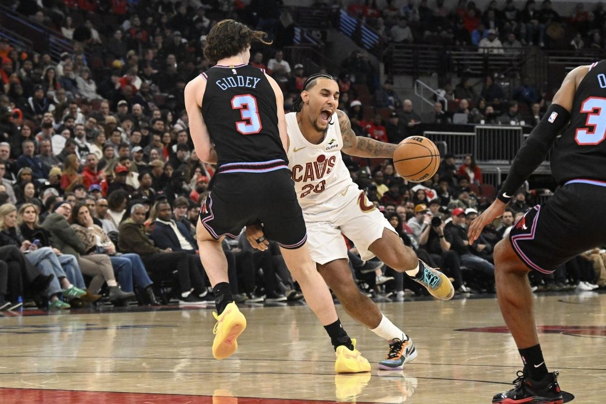 Dec 17, 2025; Chicago, Illinois, USA;  Cleveland Cavaliers guard Jaylon Tyson (20) drives to the basket against Chicago Bulls guard Josh Giddey (3) during the first half at United Center. Mandatory Credit: Matt Marton-Imagn Images