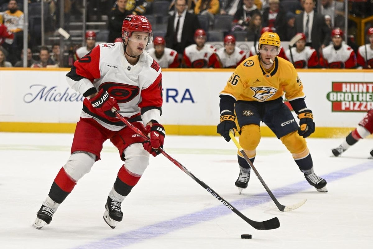 Dec 17, 2025; Nashville, Tennessee, USA;  Carolina Hurricanes center Sebastian Aho (20) skates with the puck against the Nashville Predators during the second period at Bridgestone Arena. Mandatory Credit: Steve Roberts-Imagn Images