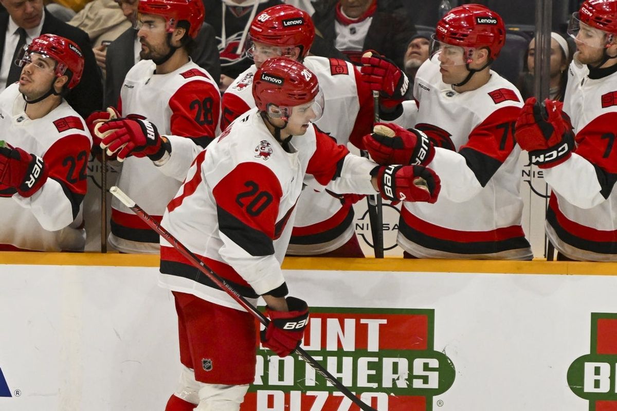 Dec 17, 2025; Nashville, Tennessee, USA; Carolina Hurricanes center Sebastian Aho (20) celebrates with his teammates after scoring a goal against the Nashville Predators  during the second period at Bridgestone Arena. Mandatory Credit: Steve Roberts-Imagn Images