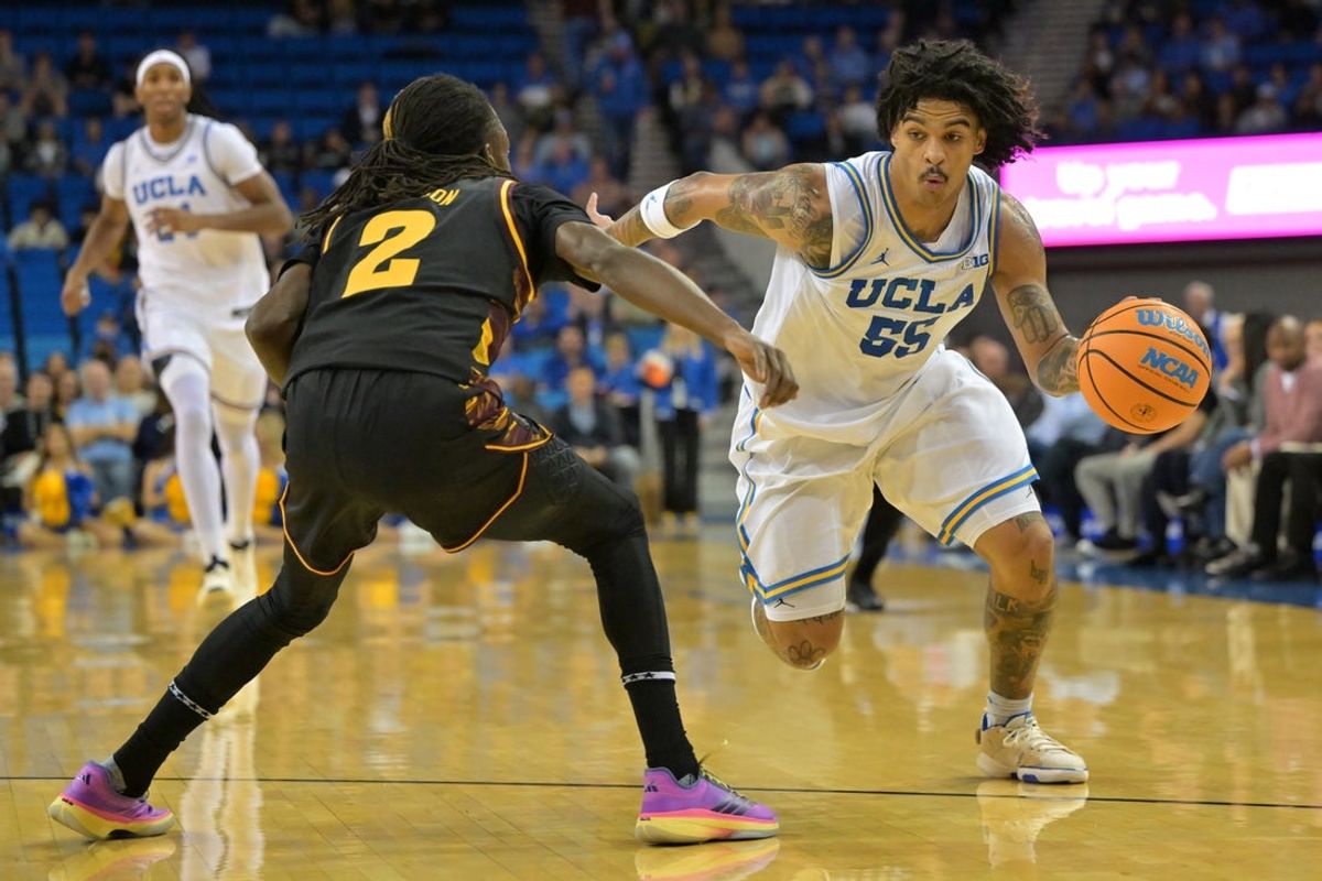 Dec 17, 2025; Los Angeles, California, USA;  UCLA Bruins guard Skyy Clark (55) is defended by Arizona State Sun Devils guard Anthony Johnson (2) as he drives to the basket in the first half at Pauley Pavilion presented by Wescom Financial. Mandatory Credit: Jayne Kamin-Oncea-Imagn Images