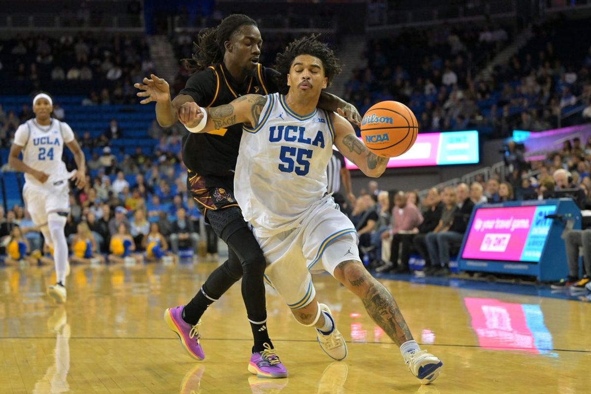 Dec 17, 2025; Los Angeles, California, USA;  UCLA Bruins guard Skyy Clark (55) is defended by Arizona State Sun Devils guard Anthony Johnson (2) as he drives to the basket in the first half at Pauley Pavilion presented by Wescom Financial. Mandatory Credit: Jayne Kamin-Oncea-Imagn Images