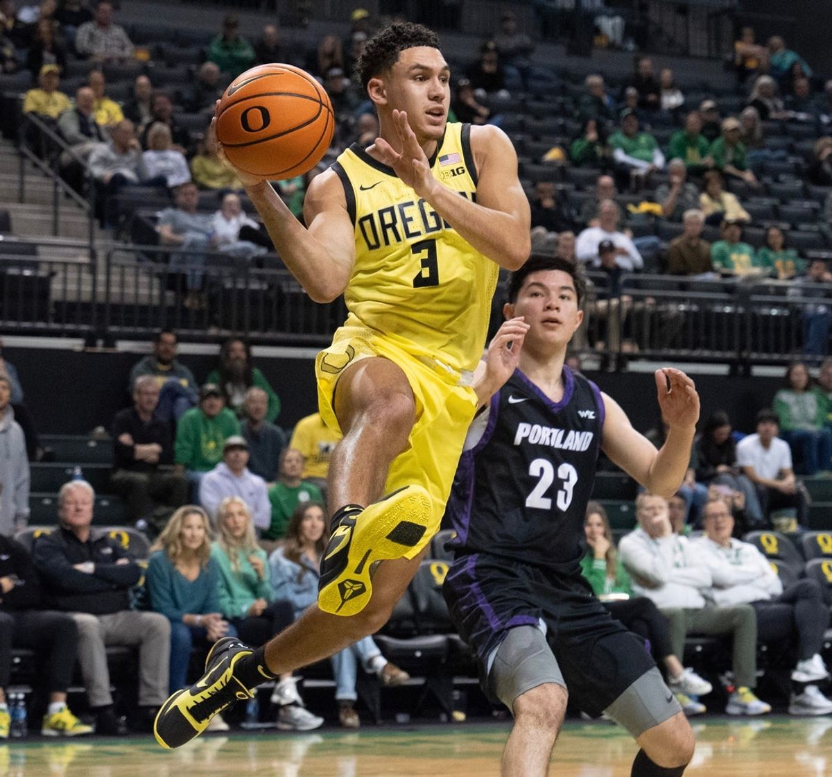 Oregon’s Jackson Shelstad, left, moves the ball against Portland’s Joel Foxwell at Matthew Knight Arena in Eugene Dec. 17, 2025.