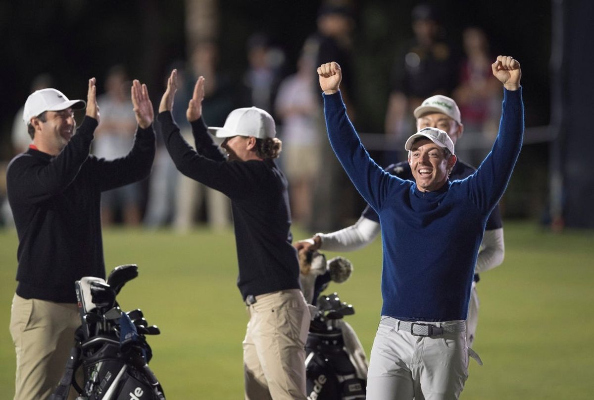Rory McIlroy, right, shot was so close to the hole that he thought he had won, but Scottie Scheffler's shot was closer as he celebrates the win with Luke Clanton at the Golf Channel Games at Trump National Golf Club on December 17, 2025, in Jupiter, Florida.