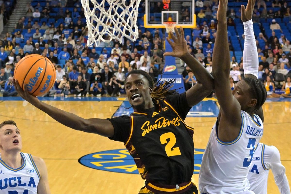 Dec 17, 2025; Los Angeles, California, USA;  Arizona State Sun Devils guard Anthony Johnson (2) drives past UCLA Bruins guard Eric Dailey Jr. (3) for a basket in the second half at Pauley Pavilion presented by Wescom Financial. Mandatory Credit: Jayne Kamin-Oncea-Imagn Images