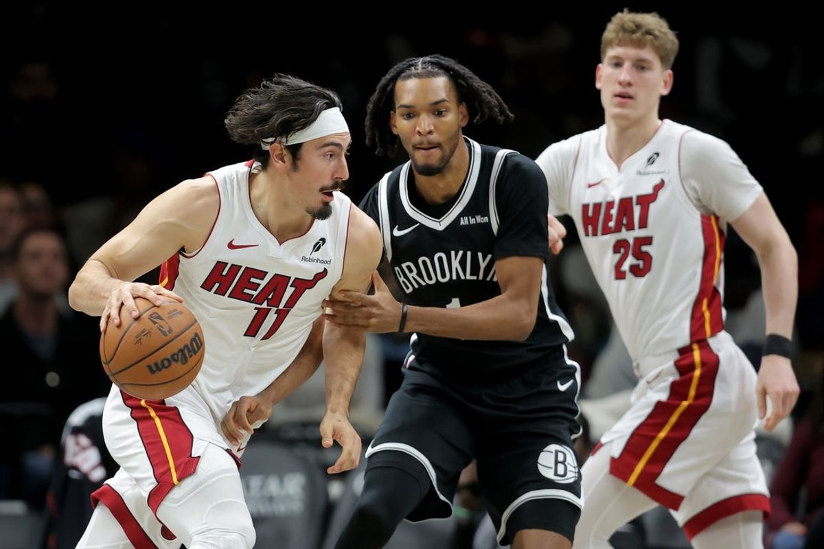 Dec 18, 2025; Brooklyn, New York, USA; Miami Heat forward Jaime Jaquez Jr. (11) controls the ball against Brooklyn Nets forward Ziaire Williams (1) during the first quarter at Barclays Center. Mandatory Credit: Brad Penner-Imagn Images