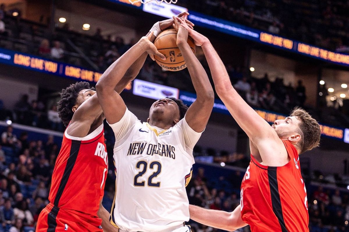 Dec 18, 2025; New Orleans, Louisiana, USA;  New Orleans Pelicans center Derik Queen (22) has a shot blocked by Houston Rockets guard/forward Amen Thompson (1) and center Alperen Sengun (28) during the first half at Smoothie King Center. Mandatory Credit: Stephen Lew-Imagn Images