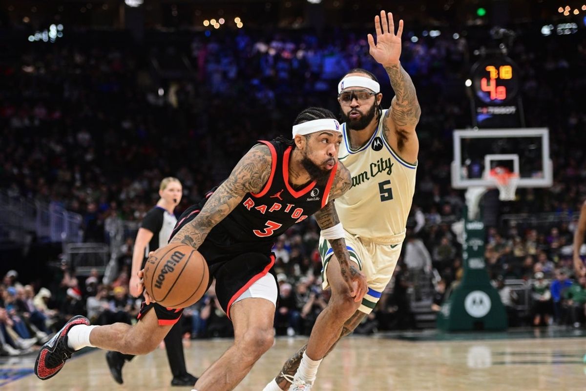 Dec 18, 2025; Milwaukee, Wisconsin, USA; Toronto Raptors forward Brandon Ingram (3) drives against Milwaukee Bucks guard Gary Trent Jr. (5) in the second quarter at Fiserv Forum. Mandatory Credit: Benny Sieu-Imagn Images