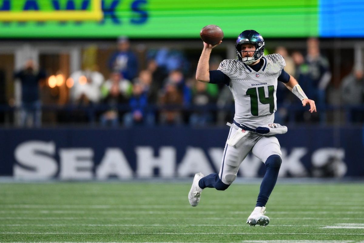 Dec 18, 2025; Seattle, Washington, USA; Seattle Seahawks quarterback Sam Darnold (14) fakes a pass as he runs against the Los Angeles Rams in the first half at Lumen Field. Mandatory Credit: Steven Bisig-Imagn Images