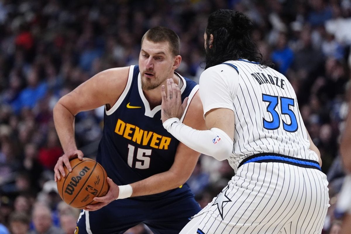 Dec 18, 2025; Denver, Colorado, USA; Orlando Magic center Goga Bitadze (35) defends on Denver Nuggets center Nikola Jokic (15) in the second quarter at Ball Arena. Mandatory Credit: Ron Chenoy-Imagn Images