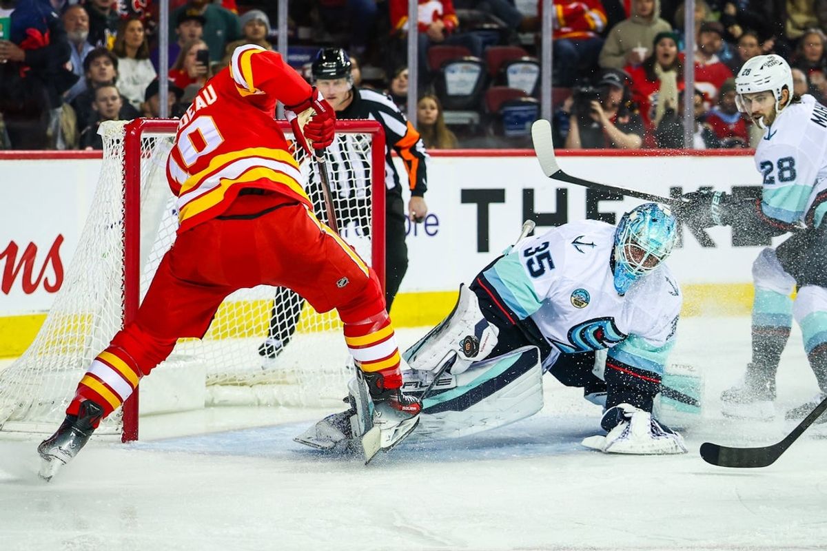 Dec 18, 2025; Calgary, Alberta, CAN; Seattle Kraken goaltender Joey Daccord (35) makes a save against Calgary Flames left wing Jonathan Huberdeau (10) during the second period at Scotiabank Saddledome. Mandatory Credit: Sergei Belski-Imagn Images