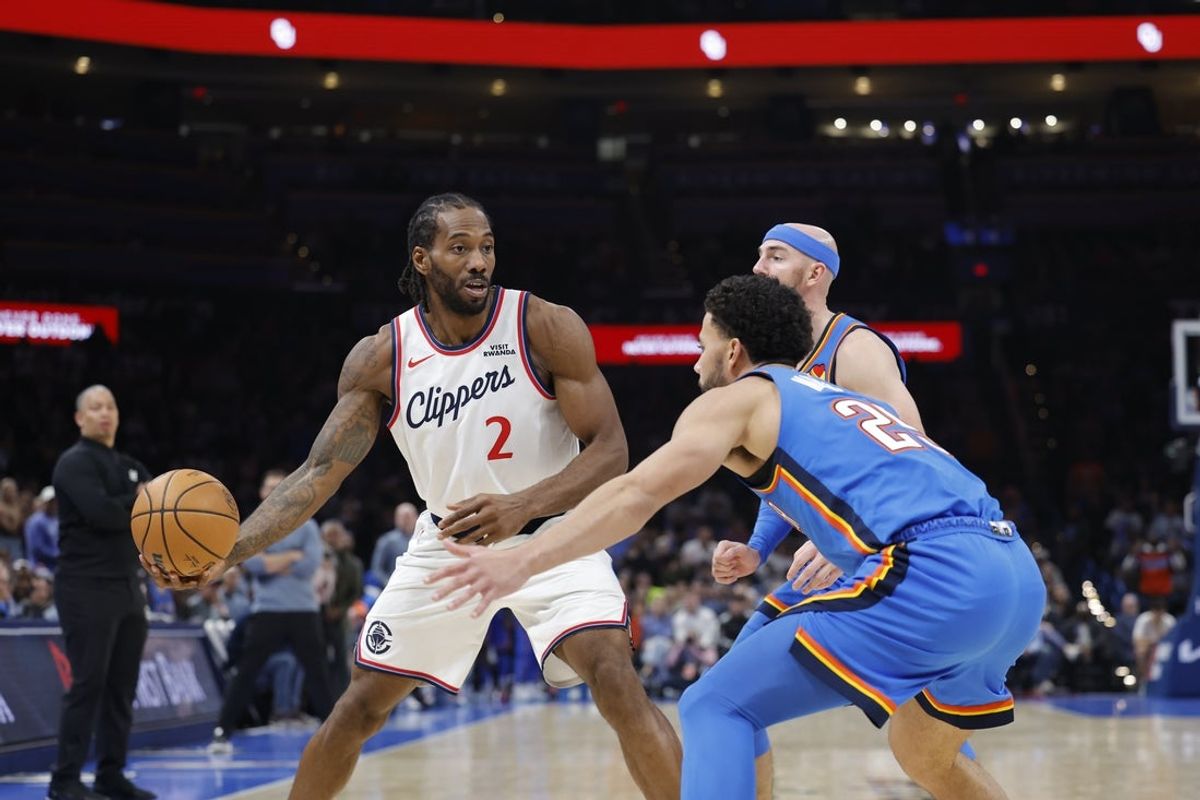 Dec 18, 2025; Oklahoma City, Oklahoma, USA; Los Angeles Clippers forward Kawhi Leonard (2) is defended by Oklahoma City Thunder guard Ajay Mitchell (25) during the second half at Paycom Center. Mandatory Credit: Alonzo Adams-Imagn Images