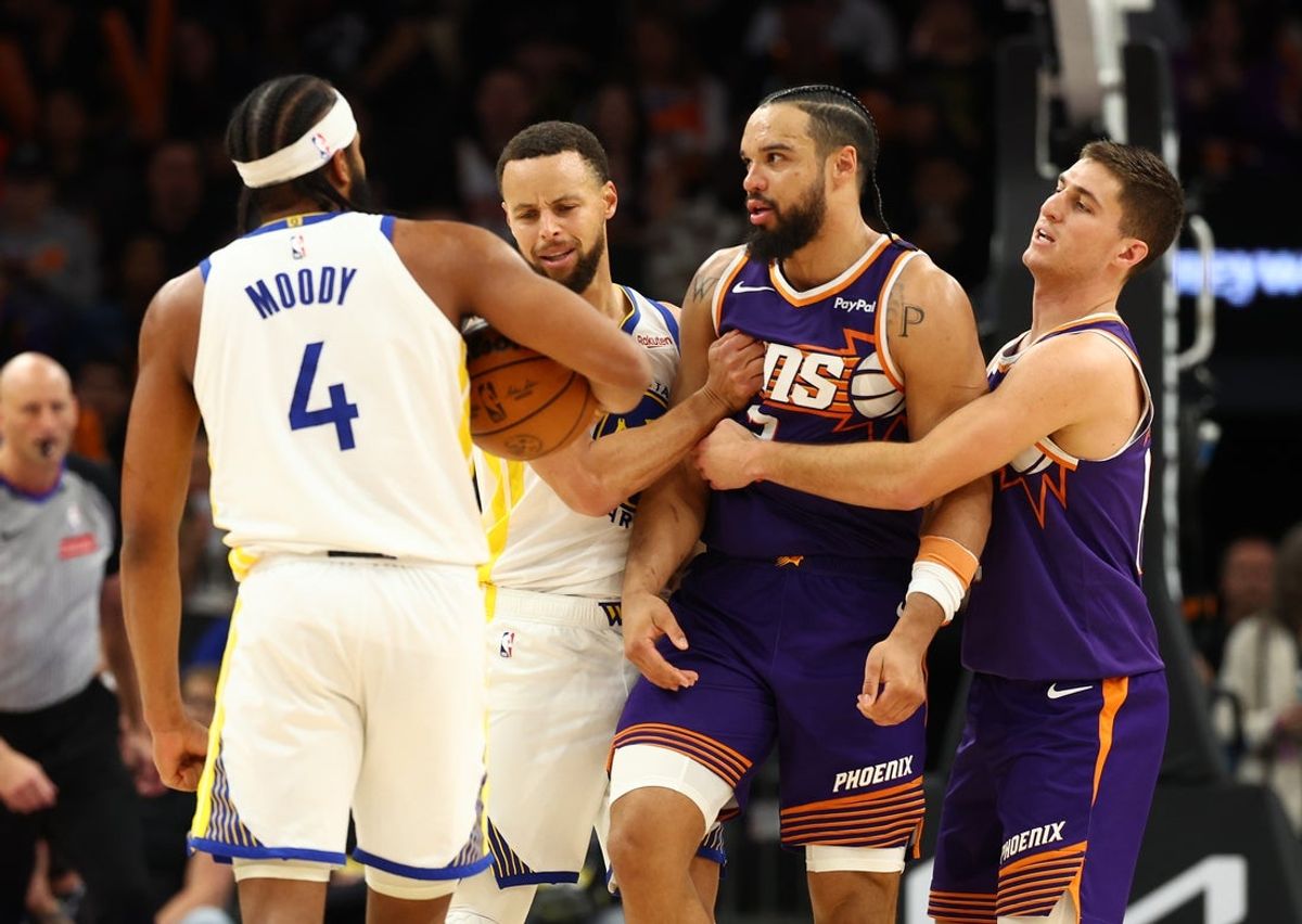 Dec 18, 2025; Phoenix, Arizona, USA; Phoenix Suns guard Collin Gillespie (right) holds back forward Dillon Brooks (3) from Golden State Warriors guard Moses Moody (4) with the help of guard Stephen Curry (30) in the second half at Mortgage Matchup Center. Mandatory Credit: Mark J. Rebilas-Imagn Images