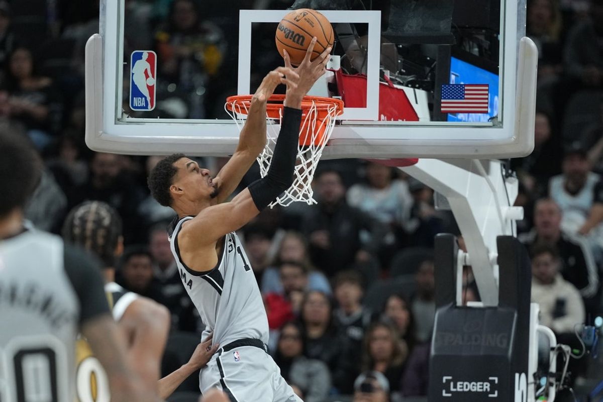 Dec 18, 2025; San Antonio, Texas, USA; San Antonio Spurs forward Victor Wembanyama (1) catches the ball on an alley-oop pass during the second half against the Washington Wizards at Frost Bank Center. Mandatory Credit: Scott Wachter-Imagn Images