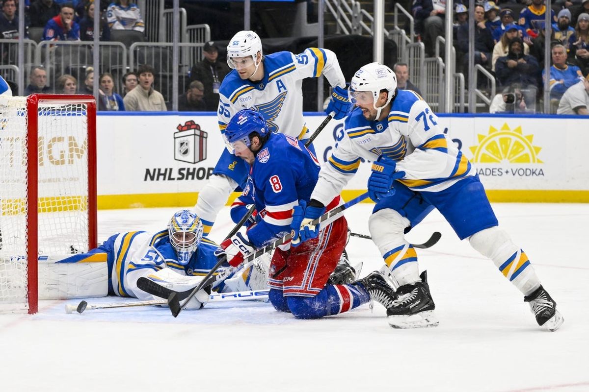 Dec 18, 2025; St. Louis, Missouri, USA; St. Louis Blues goaltender Jordan Binnington (50) defenseman Colton Parayko (55) and defenseman Justin Faulk (72) defends the net against New York Rangers left wing J.T. Miller (8) during the third period at Enterprise Center. Mandatory Credit: Jeff Curry-Imagn Images